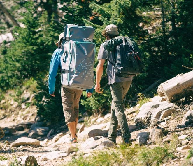 Two men hiking, carrying a Travel Bag 