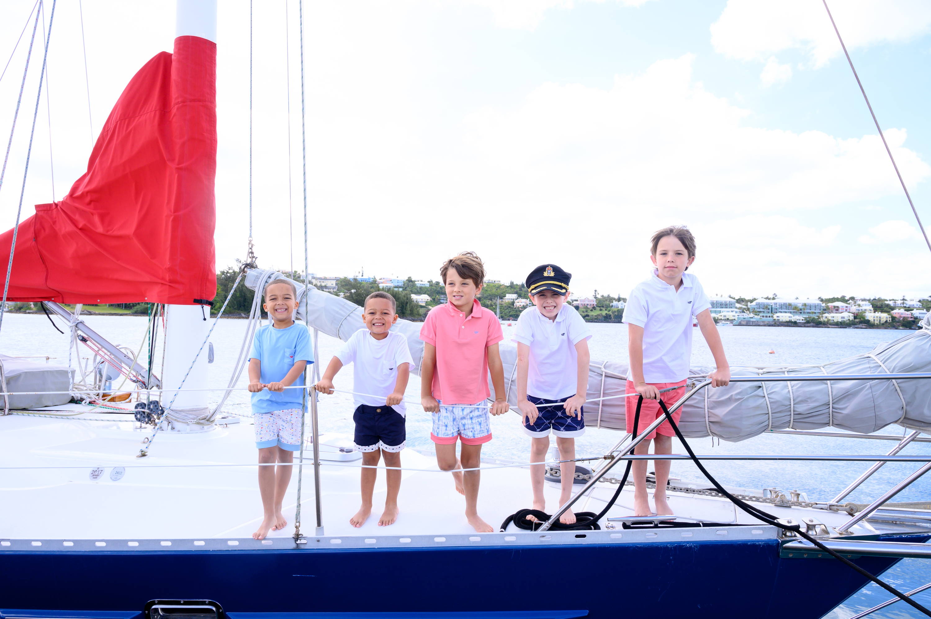 All the kids on boat in our summer 2022 collection of polos, tees and shorts.