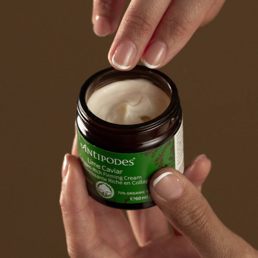 Hands holding Lime Caviar Collagen-Rich Firming Cream.