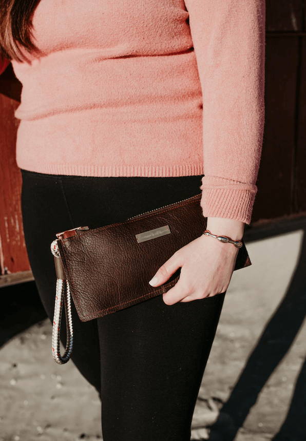 woman holding leather clutch