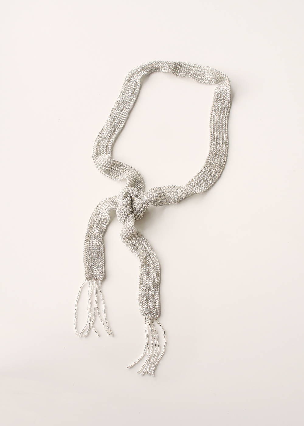 A silver beaded necktie with tasselled ends