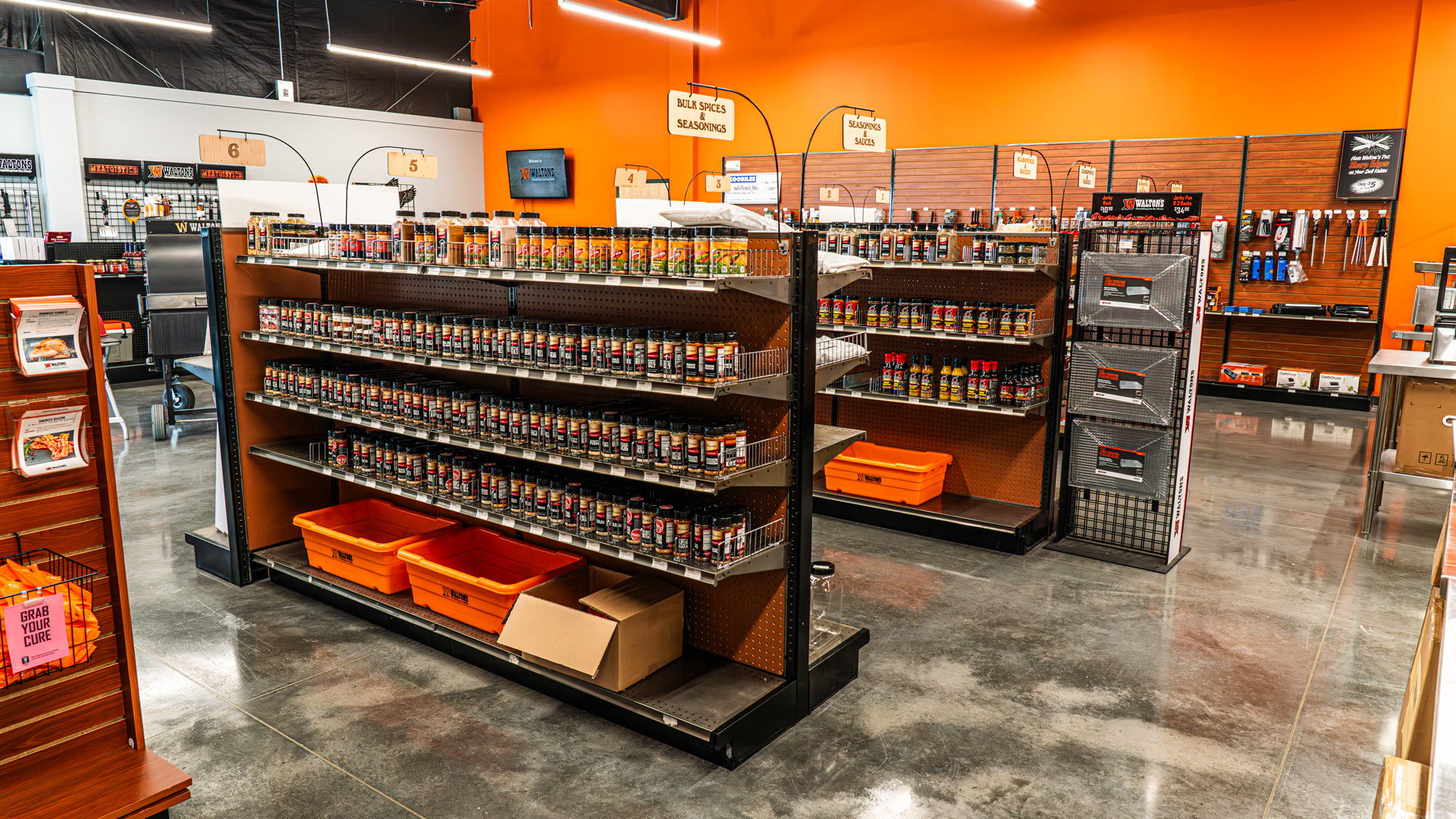 Interior of a Walton's retail store with shelves displaying various products.