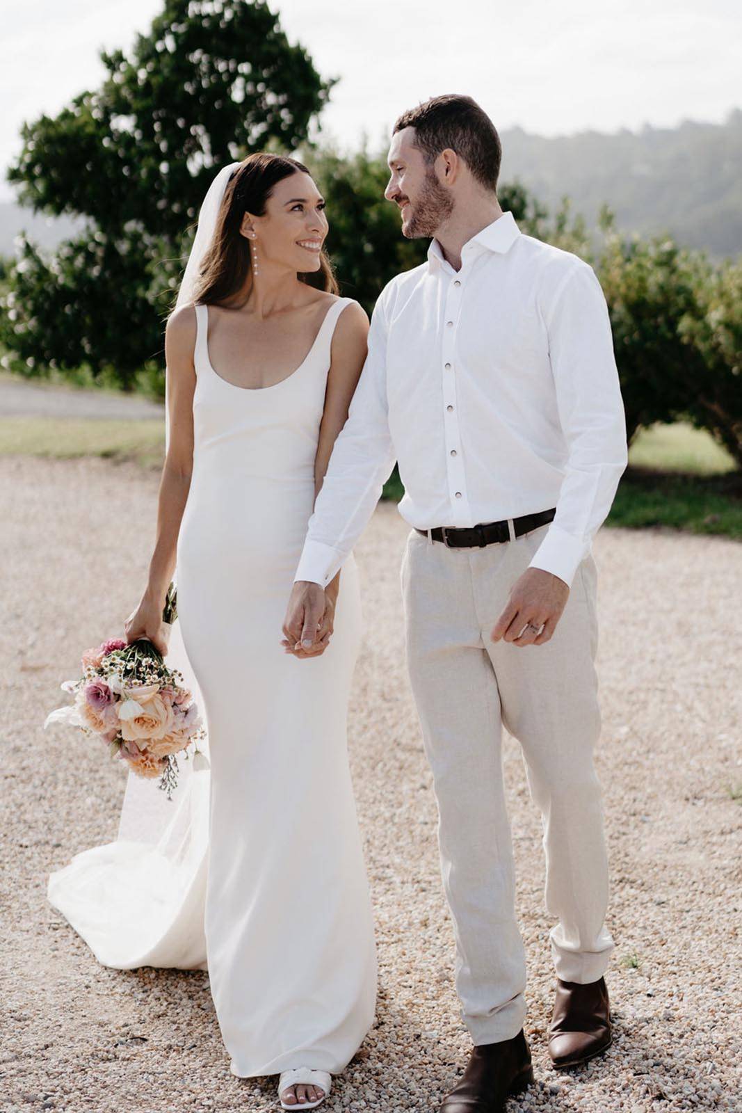 Bride and Groom smiling at each other