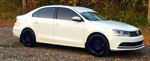 Side profile white 2015 Volkswagen TDI Jetta with blue wheels autumn trees Rhino 3 Liter horn kit featured customer install gallery photo 1