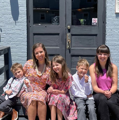 Jamie Fuller and her four kids sitting on porch.