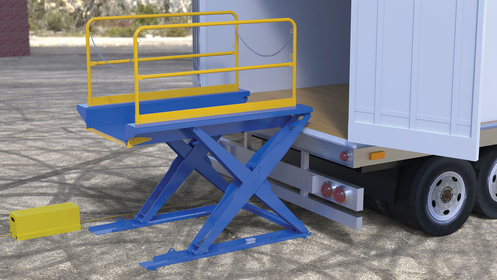 A blue and yellow scissor lift next to a truck.