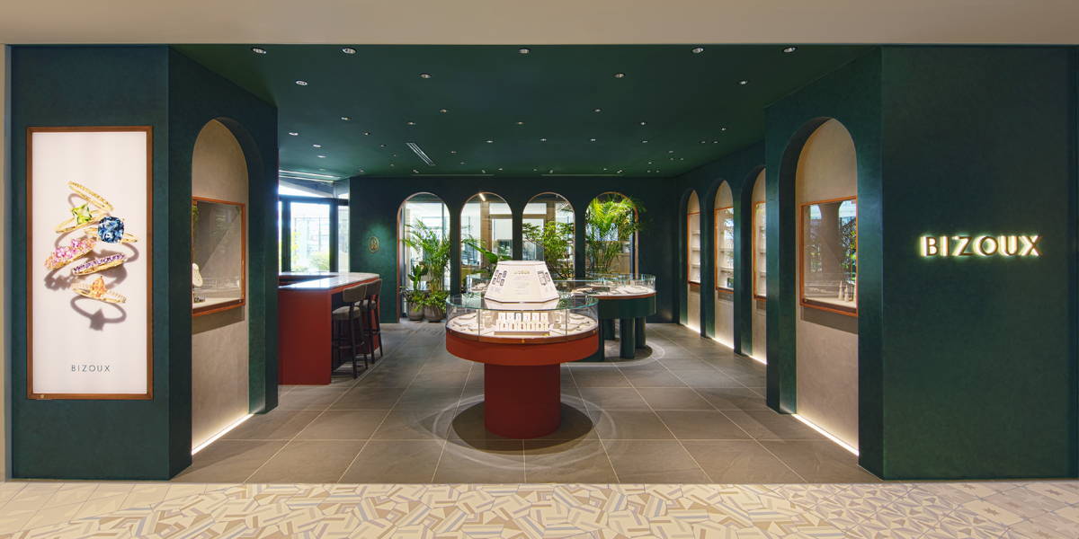 Interior of a modern retail space with displays and greenery.