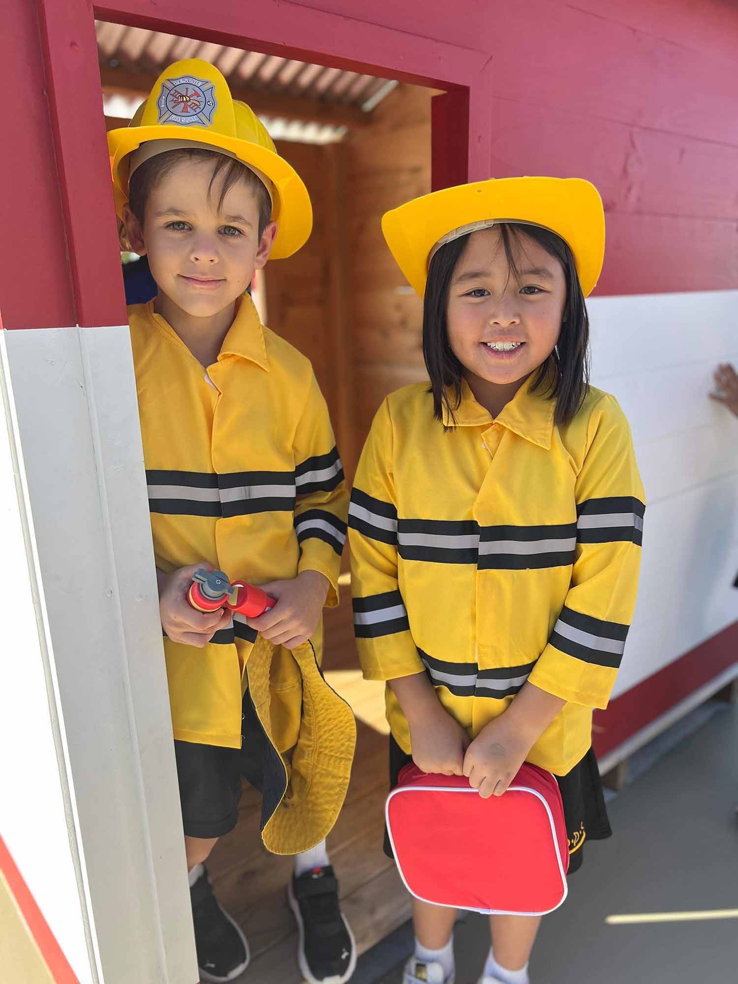 Kids playing in their primary school wooden cubby house