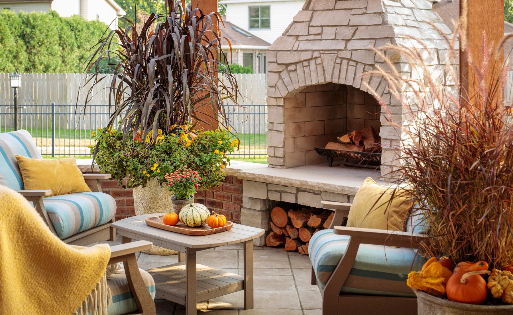 Scene of backyard fireplace patio with Luscious® Goldengate™, Graceful Grasses® Purple Fountain Grass, ColorBlaze® Chocolate Drop, Graceful Grasses® Vertigo®