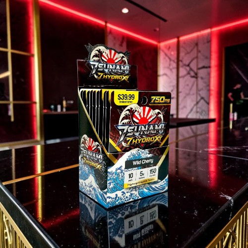Box of energy drink packets on a glossy black surface.