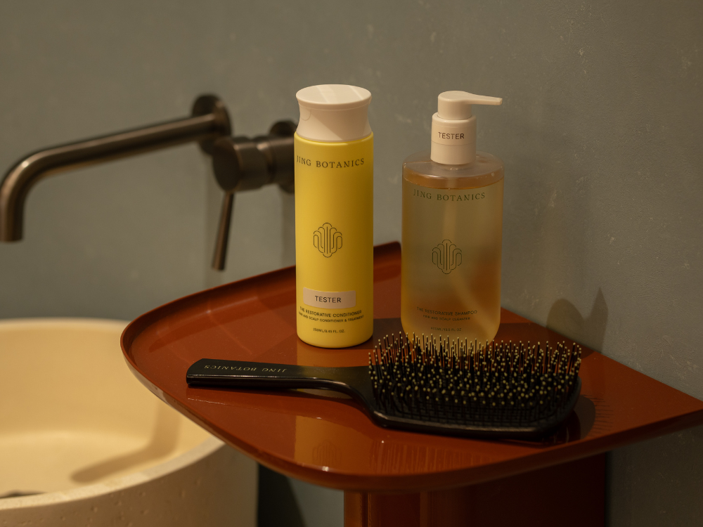jing botanics shampoo and conditioner placed on a side shelf