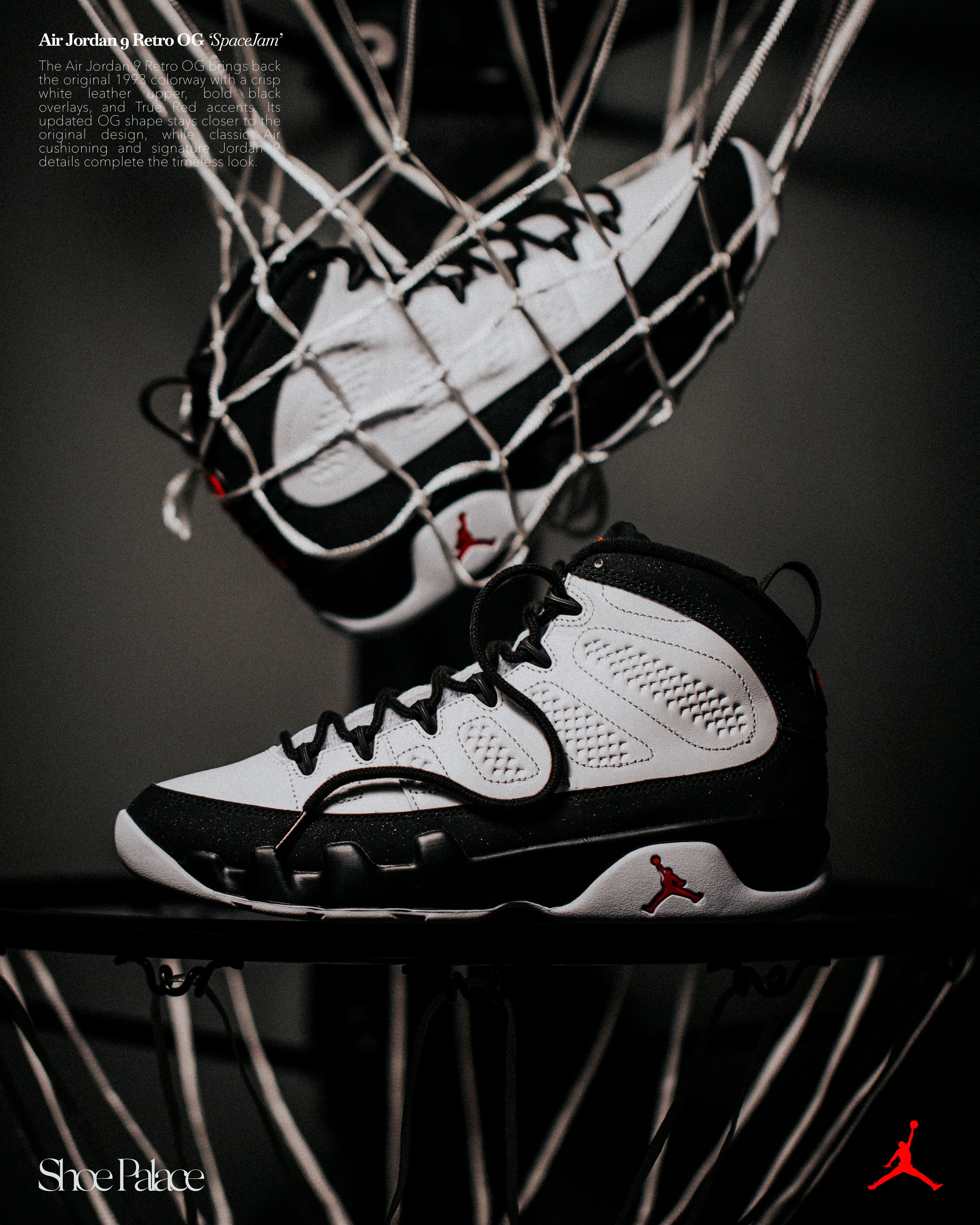 A pair of black and white basketball shoes in a net.