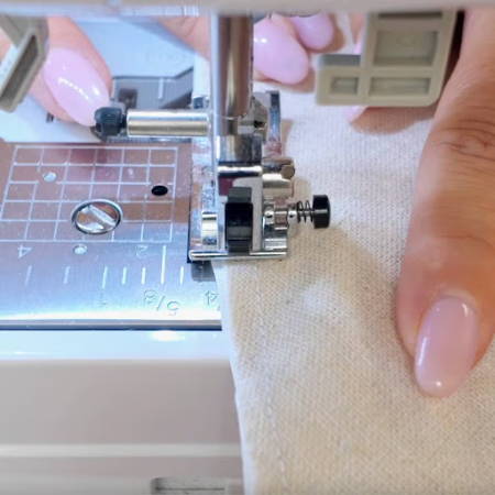 Sewing the lining and outer fabric together with a sewing machine to make a flower bag