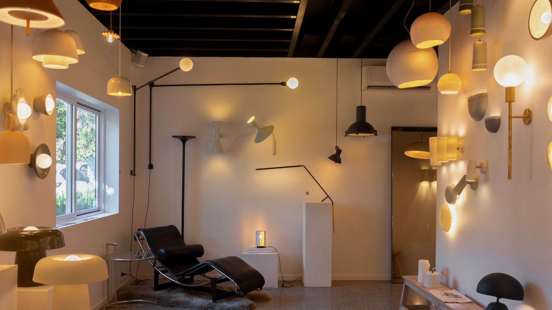 Interior of a well-lit showroom with various hanging light fixtures.