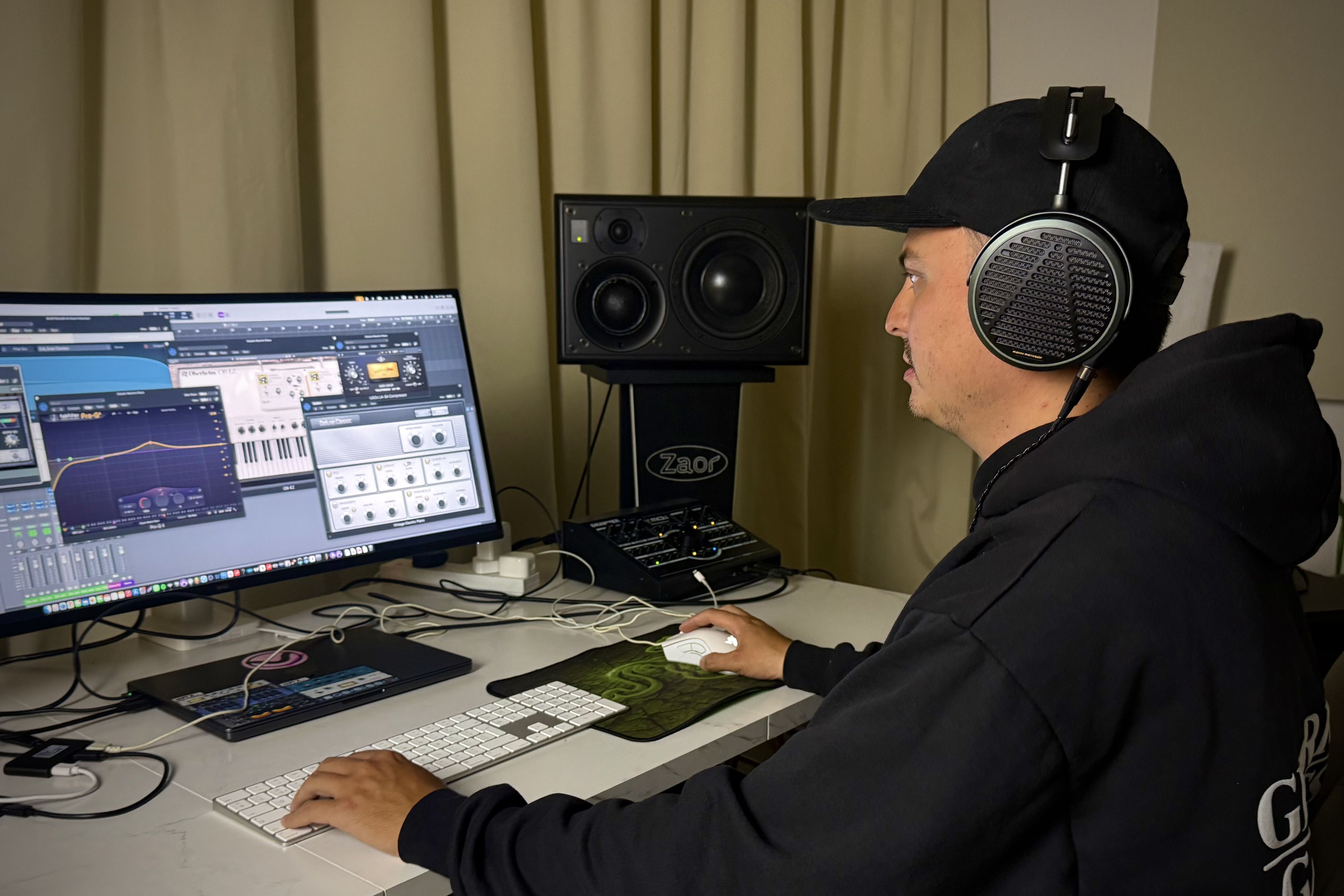 Command Strange wearing Audeze MM-500 headphones mixing in the studio 