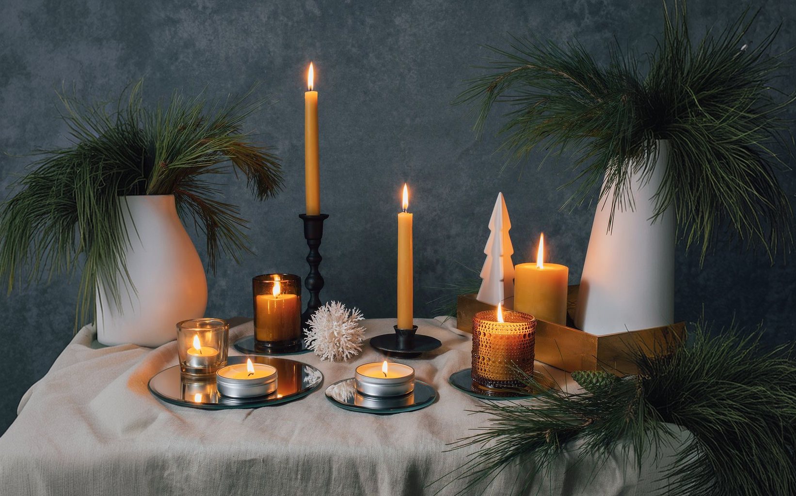Holiday table set with lit Bluecorn beeswax candles