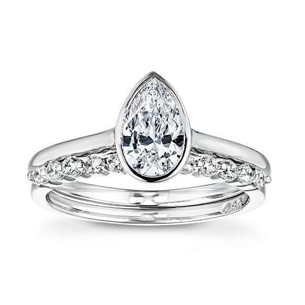 White gold wedding set featuring a simple solitaire and a diamond accented wedding band