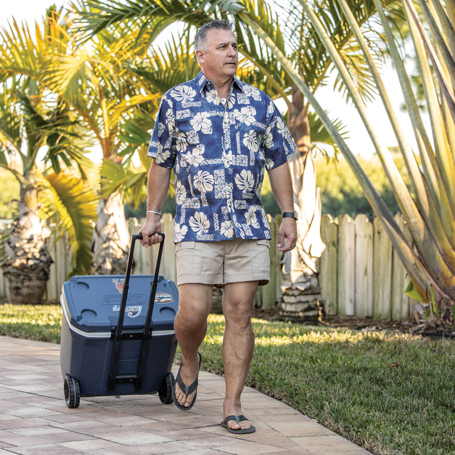 Man walking through resort with cooler wearing Sportif original cargo short.