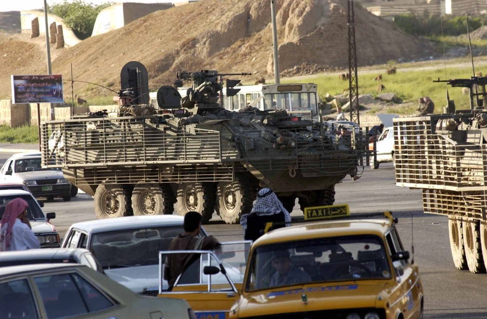 Soldiers from the 2nd Battalion, 3rd Infantry Regiment drive in a convoy of Strykers through a traffic jam in Mosul, Iraq. As a part of the 3rd Brigade, 2nd Infantry Division (Stryker Brigade Combat Team), the Soldiers are among the first to ever use the vehicle in a combat zone.