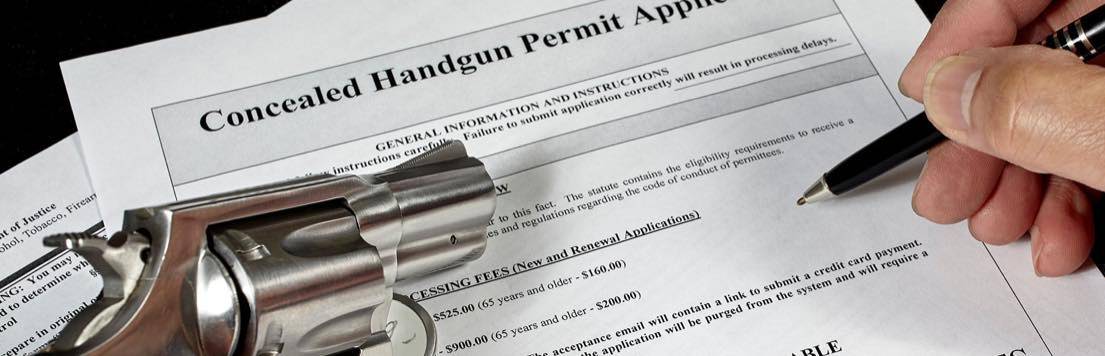 Man filling out oncealed carry permit for handgun