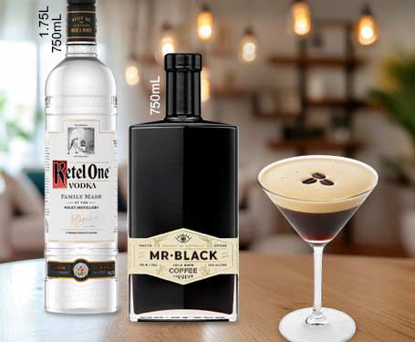 Two bottles of alcohol and a cocktail in a glass.