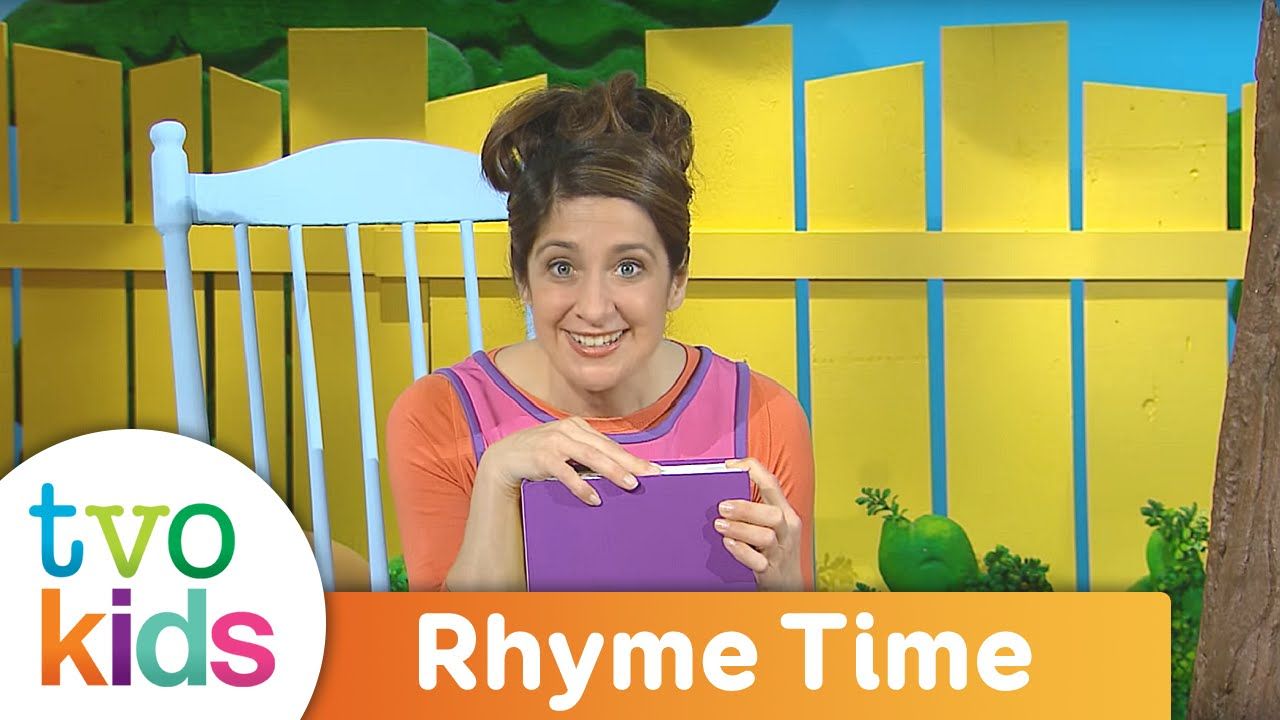 Person in a colorful setting, engaging with a book for children’s rhymes.