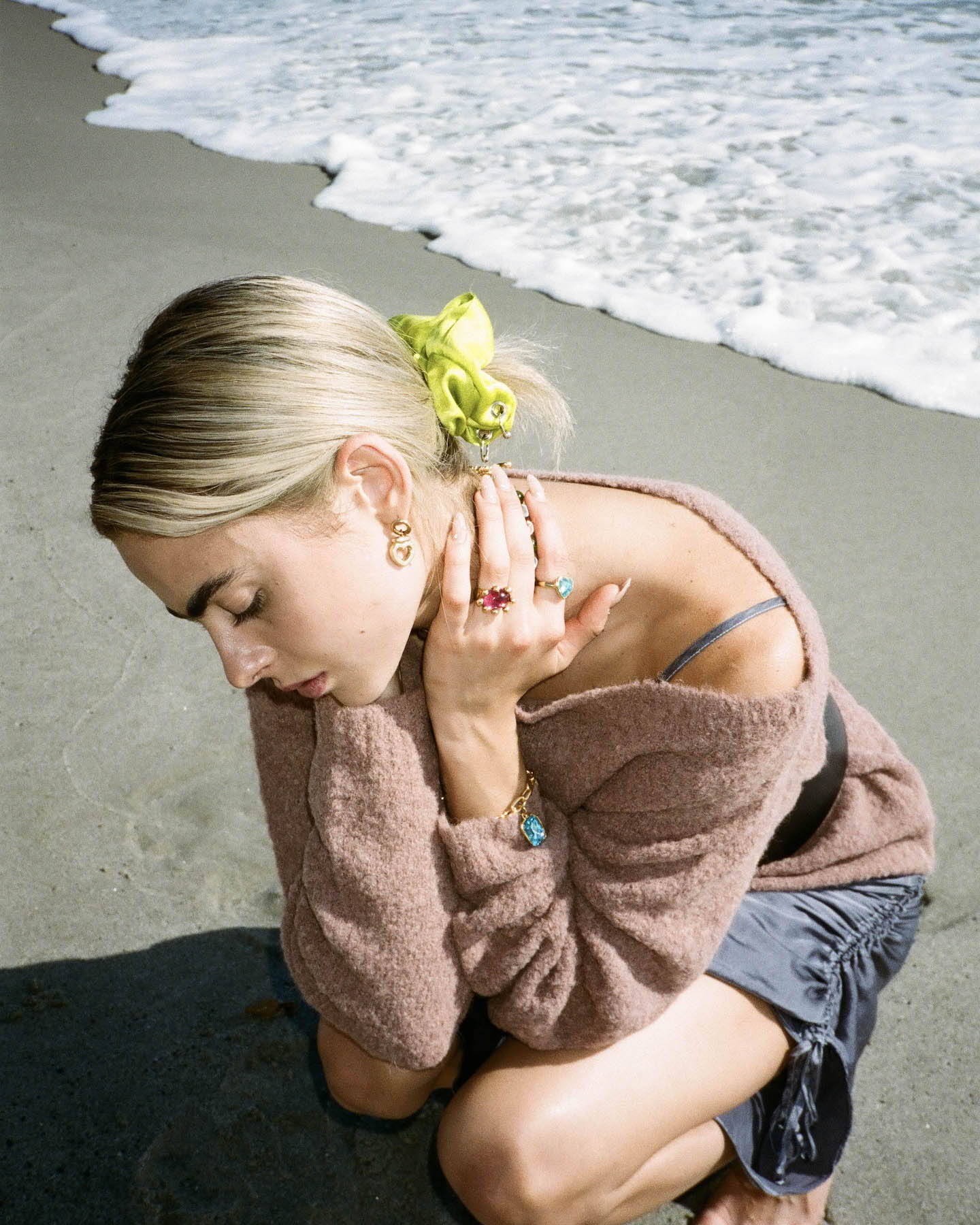 Model on the beach wearing Rachel Comey sweater, SVNR dress, Modo Mondo jewelry and Kkco scrunchie.