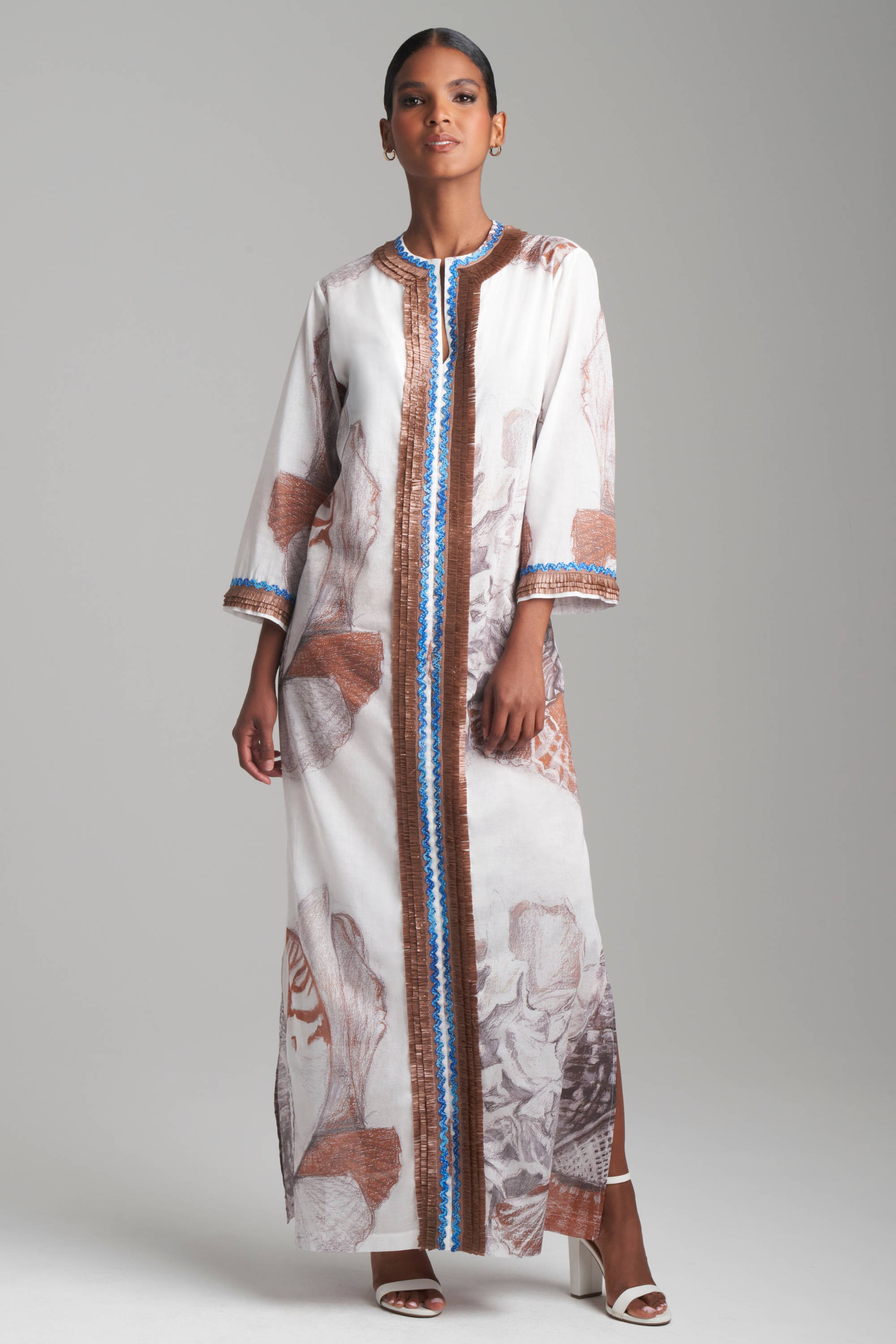 Woman wearing cotton shell printed kaftan with brown trim by Ala von Auersperg