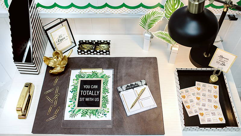 Teacher desk decorated with Simply Boho classroom decor and teaching supplies
