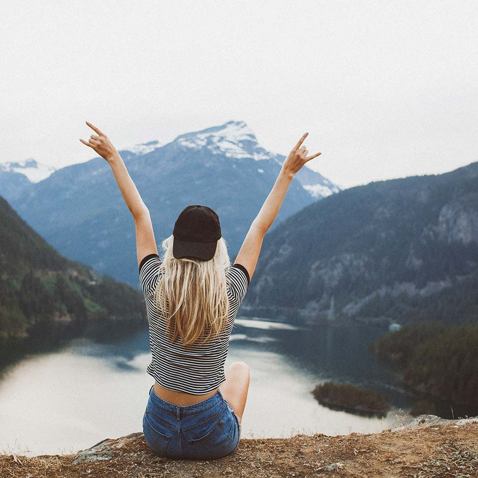 female sitting on mountain side