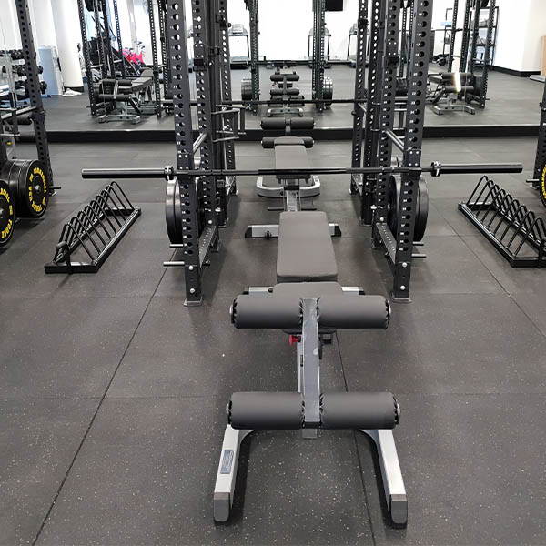 Fire Station Gym Fit Out showcasing a multi-functional bench with leg roller for enhanced lower body workouts.