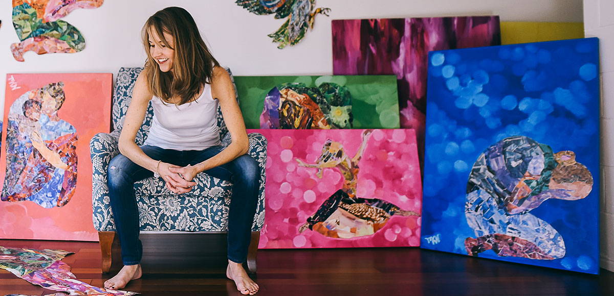 Meghan Nathanson sitting with collages on canvas