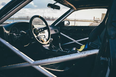 Photo of rally car with roll cage interior.