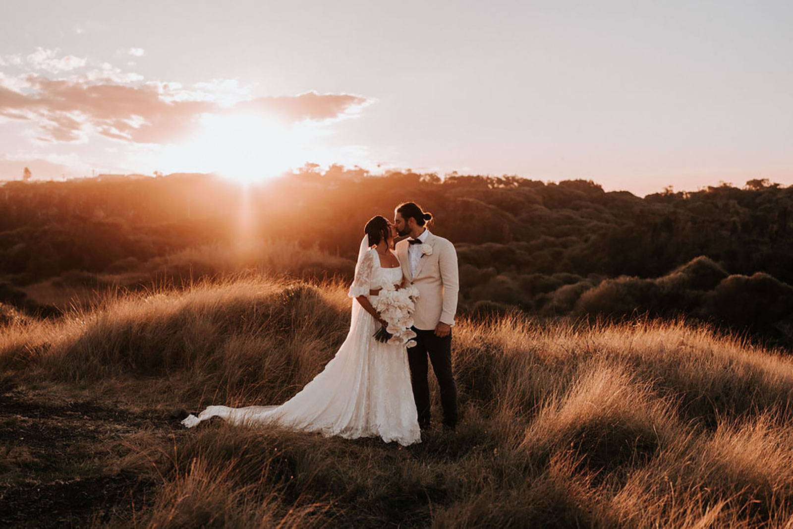 GRACE Bride Ellie in the Behati Set kissing her new husband in Gerringong Hillside