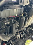 Close-up of dual-trumpet air horn kit and air tank mounted under vehicle chassis