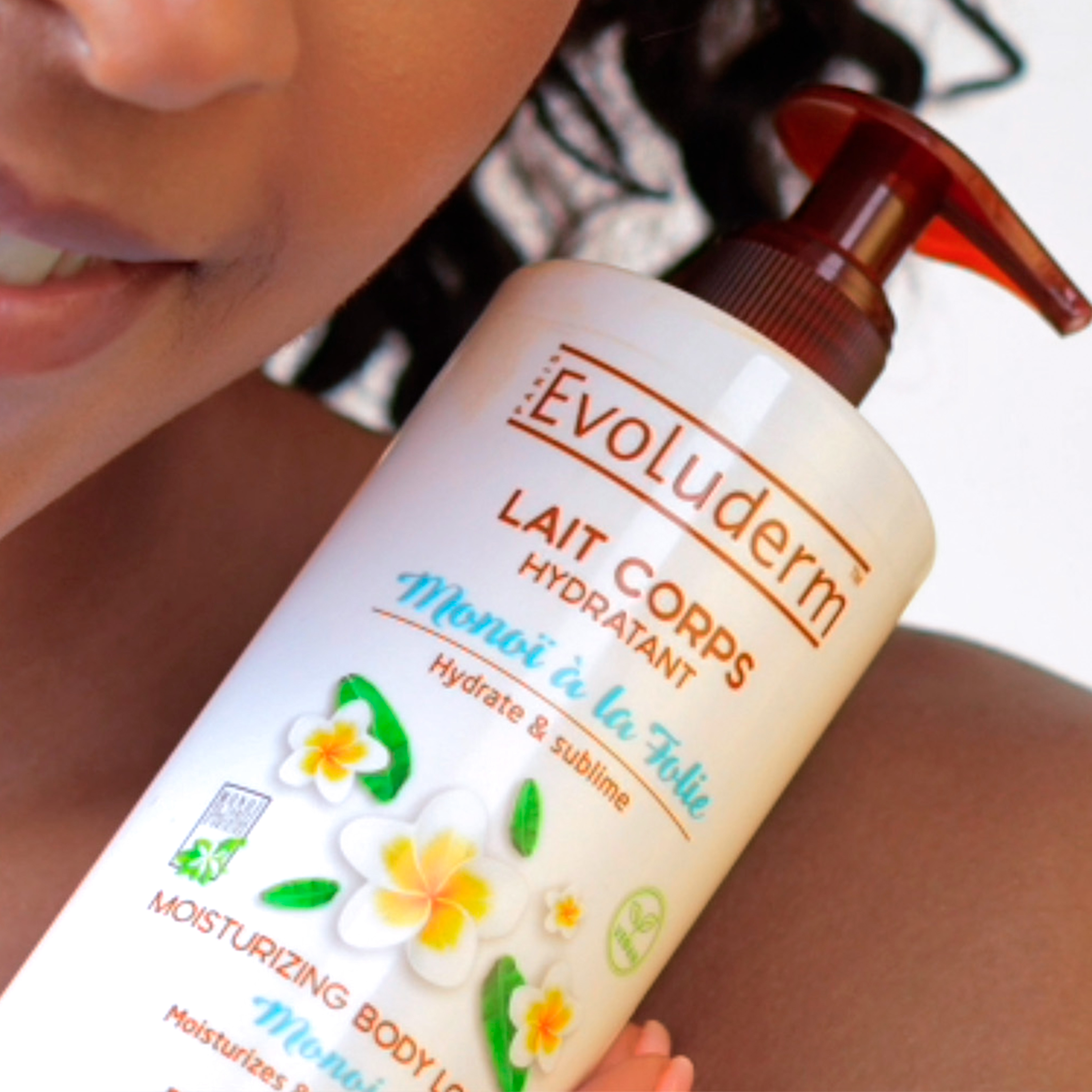 Person holding a bottle of Evoluderm moisturizing body lotion.