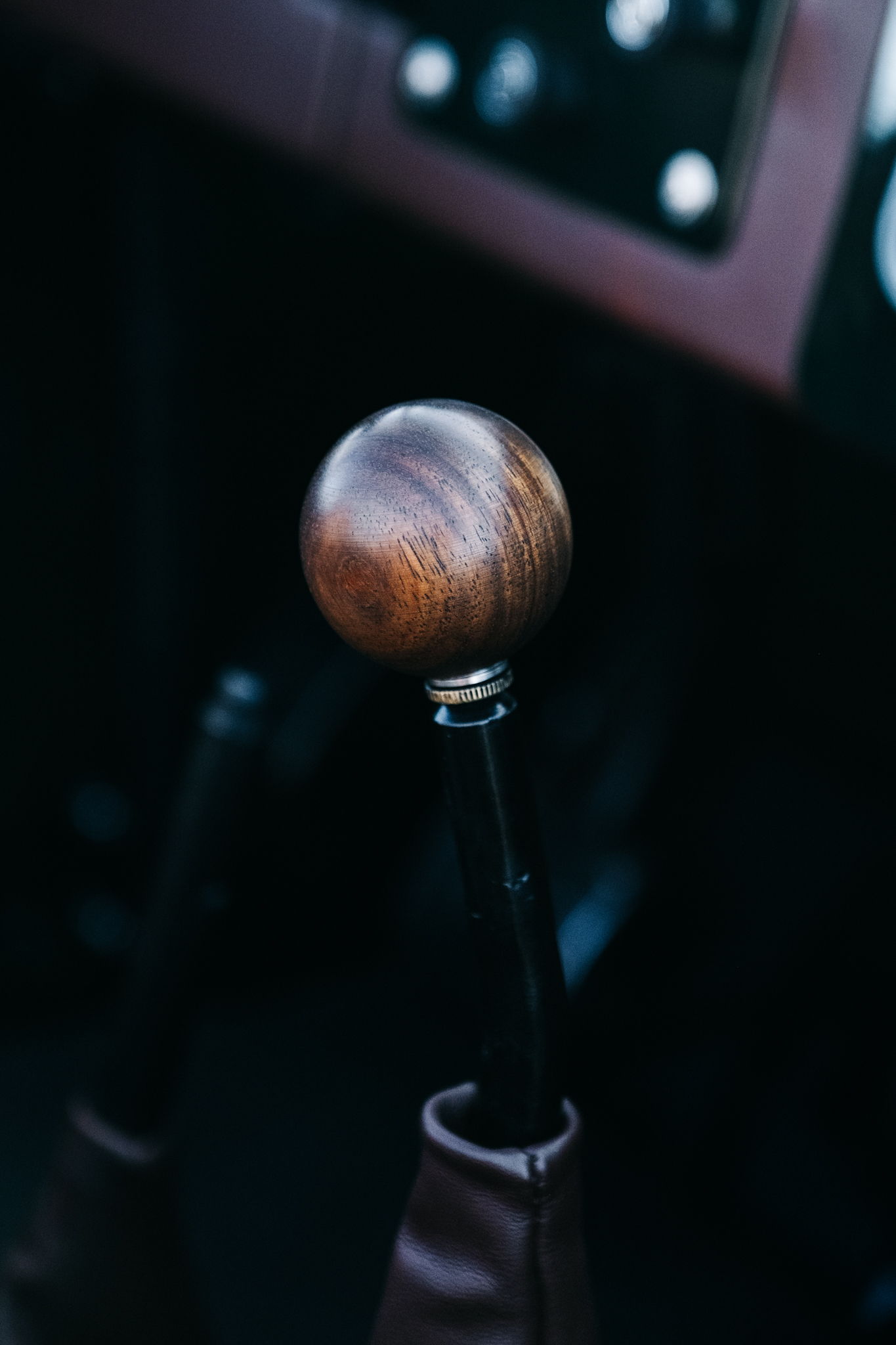 Wooden gear shift knob in a vehicle interior.
