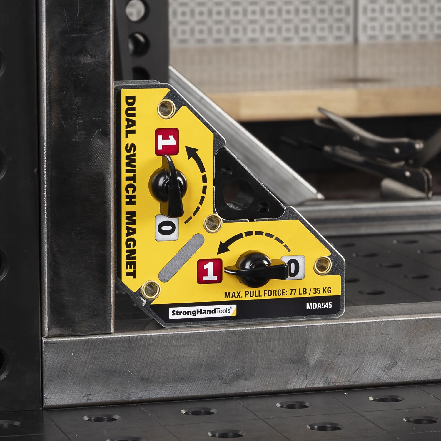 Dual switch magnet tool on a metal work surface.