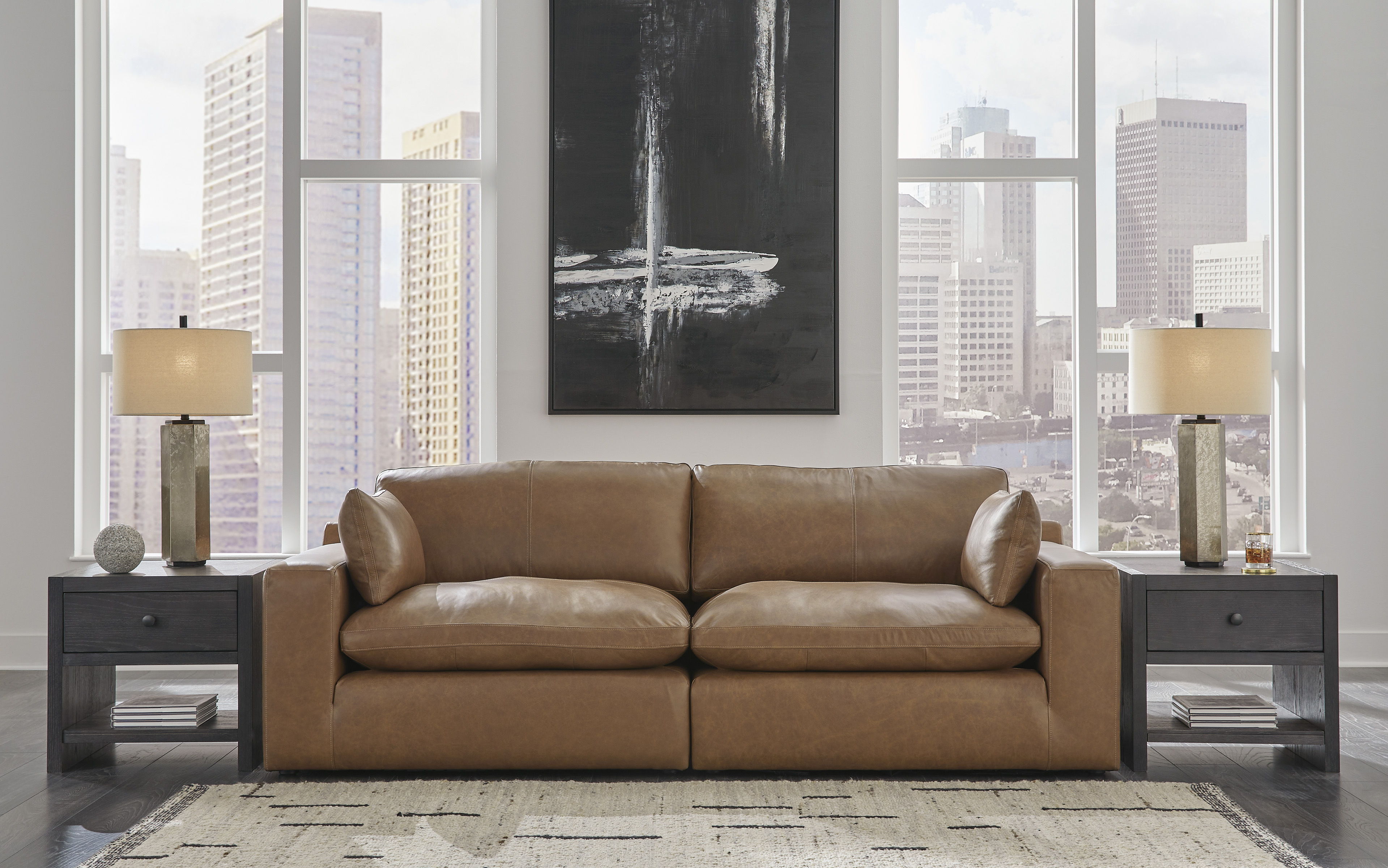 Modern living room with a brown leather sofa and decorative lamps.