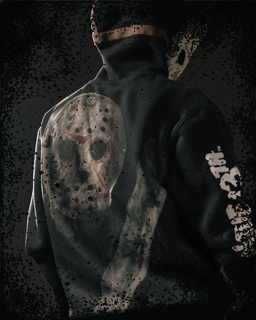 Person wearing a black hoodie with a skull design on the back.