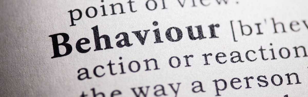 close up of the dictionary description of behaviour