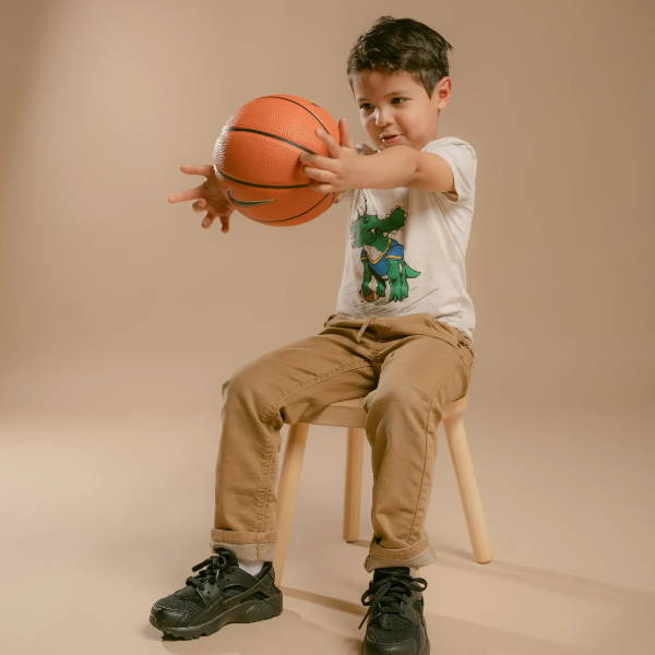 young boy holding basketball