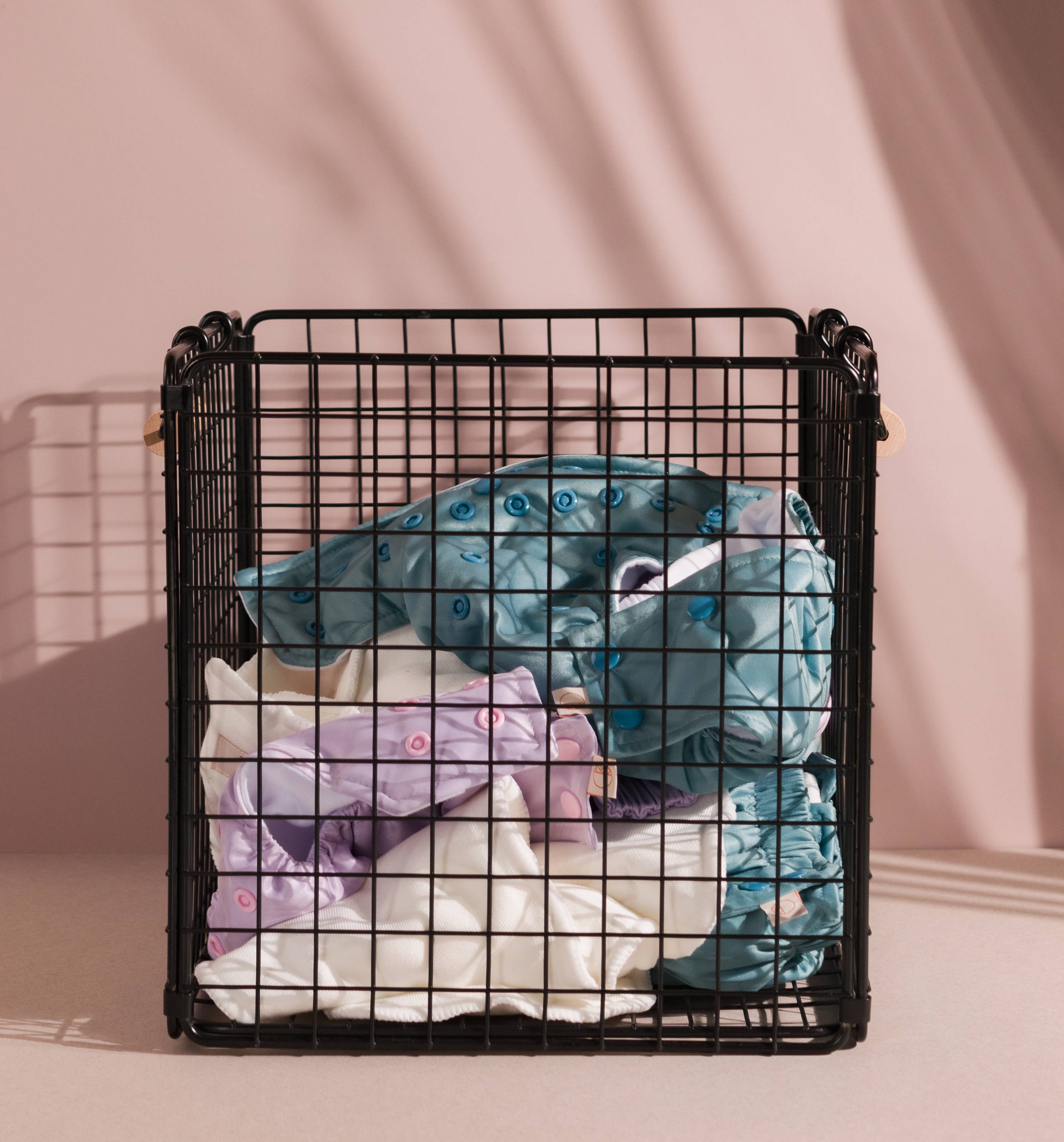Sassy by Nestling Cloth Nappies in a wash basket