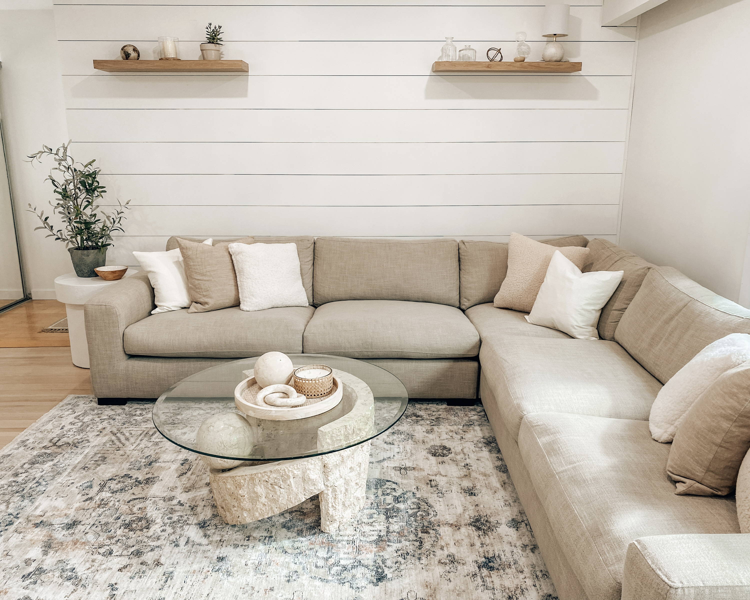 A cream coloured sectional in a bright living room.