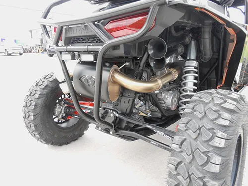 Rear three-quarter gold exhaust black muffler Turner Eagle control arm white coilover LED light pods KJ Motorsports RZR 1000 Turbo gallery photo 3