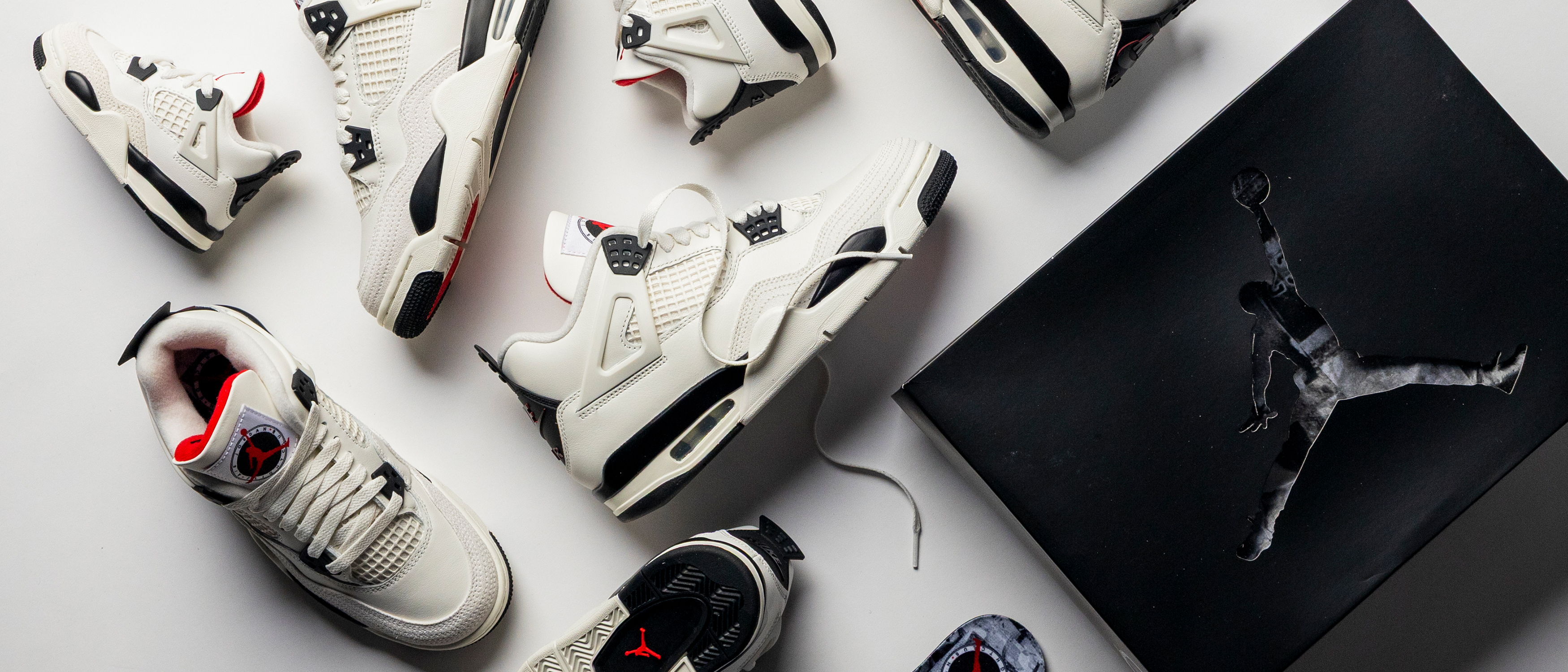 Various styles of sneakers arranged with a black Jordan box.
