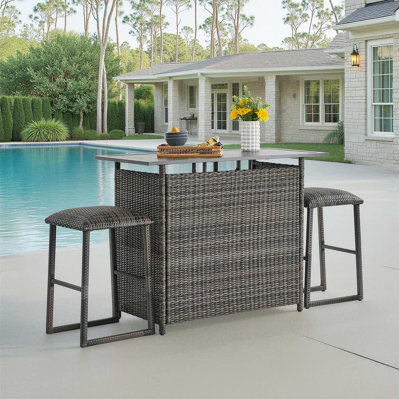 Outdoor bar table with two stools by a swimming pool.