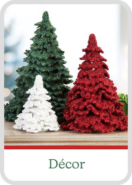 Three decorative Christmas yarn trees in green, white, and red.