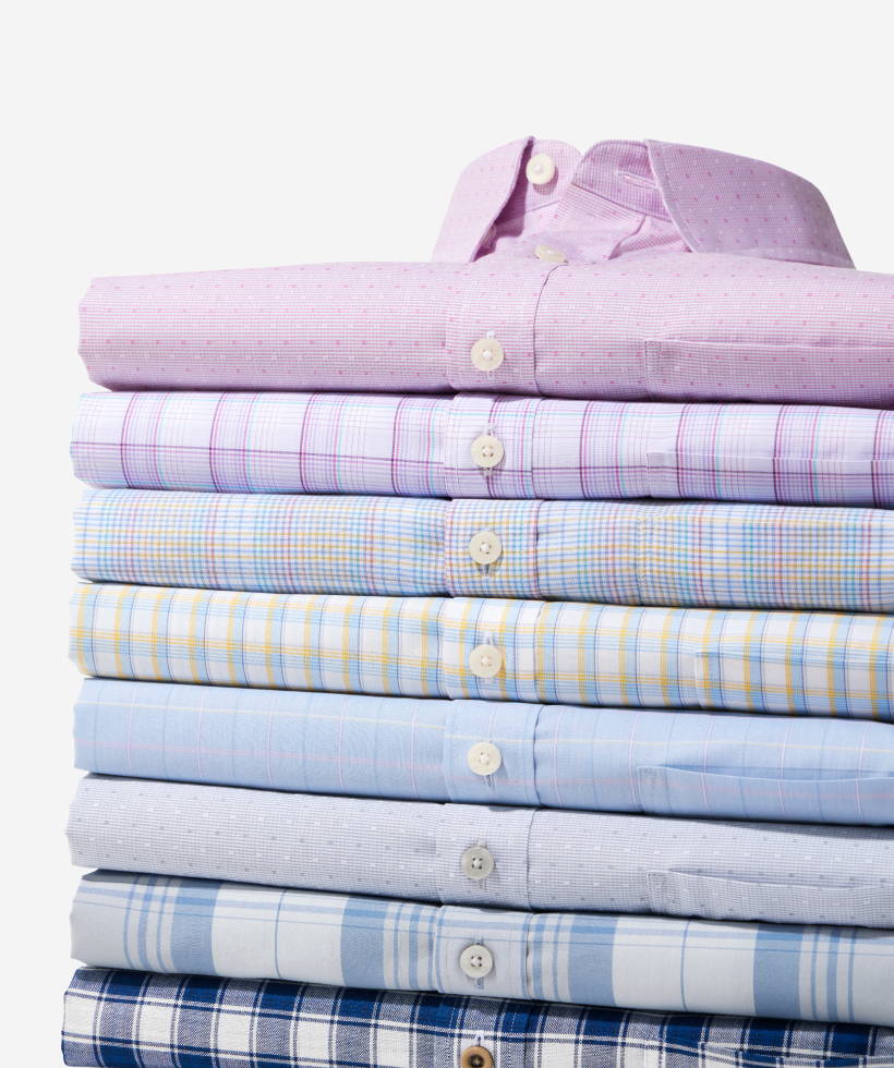 Stack of UNTUCKit wrinkle-free shirts