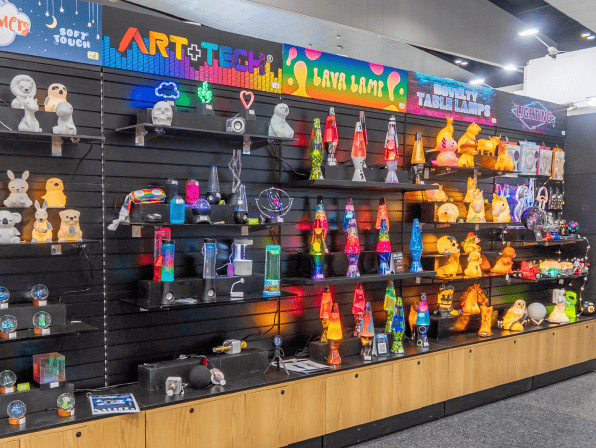 Colorful display of toys and figures on shelves at an exhibition.